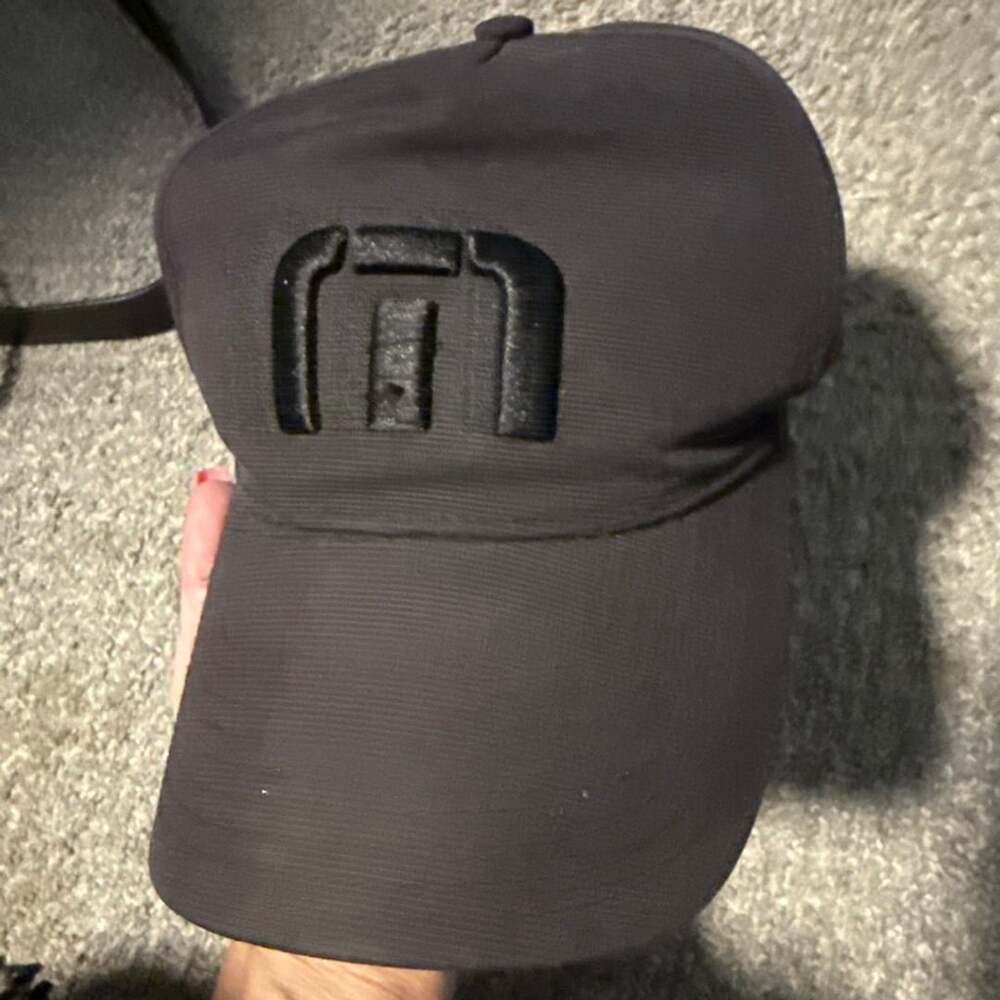 TravisMathew Black Snapback Hat with Embroidered Logo
